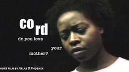 A film poster featuring a person from the shoulders up accompanied by text. The person is looking down wearing a white shirt while in front of a black background. The person has dark brown skin with short dark brown curly hair. On the left side of the poster, the title of the film is broken up into two halves at different heights. The tagline, written beneath the title, is also segmented. It reads: "Do you love your mother?" In the bottom left corner, an additional bit of text reads: "short film by Atlas O. Phoenix."